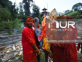 Nepali Hindu devotees carry an eco-friendly idol of Lord Bishwokarma to immerse it in the Bagmati River in Kathmandu, Nepal, on September 18...