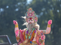 An eco-friendly idol of the Nepali Hindu god Bishwokarma is pictured on top of a vehicle as it is taken for immersion into the Bagmati River...