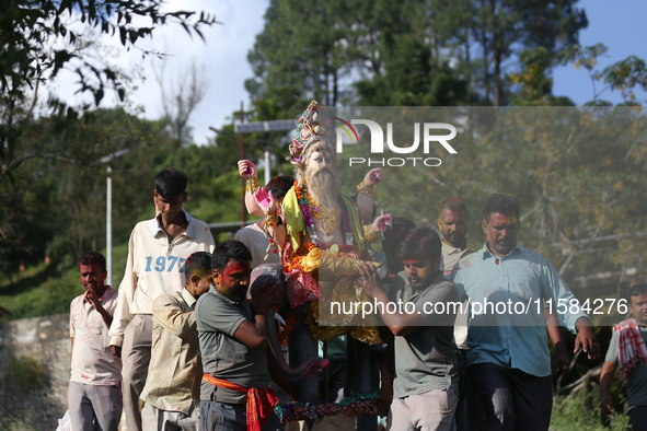 Nepali Hindu devotees carry an eco-friendly idol of Lord Bishwokarma to immerse it in the Bagmati River in Kathmandu, Nepal, on September 18...