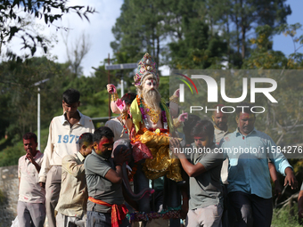 Nepali Hindu devotees carry an eco-friendly idol of Lord Bishwokarma to immerse it in the Bagmati River in Kathmandu, Nepal, on September 18...