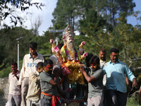 Nepali Hindu devotees carry an eco-friendly idol of Lord Bishwokarma to immerse it in the Bagmati River in Kathmandu, Nepal, on September 18...