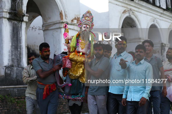 Nepali Hindu devotees carry an eco-friendly idol of Lord Bishwokarma to immerse it in the Bagmati River in Kathmandu, Nepal, on September 18...