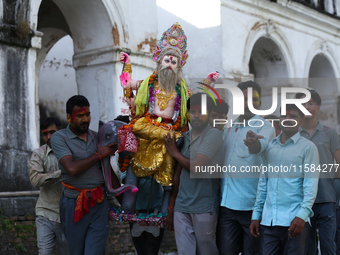 Nepali Hindu devotees carry an eco-friendly idol of Lord Bishwokarma to immerse it in the Bagmati River in Kathmandu, Nepal, on September 18...