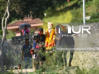 Nepali Hindu devotees carry an eco-friendly idol of Lord Bishwokarma to immerse it in the Bagmati River in Kathmandu, Nepal, on September 18...