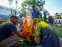 Nepali Hindu devotees perform rituals before they immerse an eco-friendly idol of the Hindu god Bishwokarma in the Bagmati River in Kathmand...