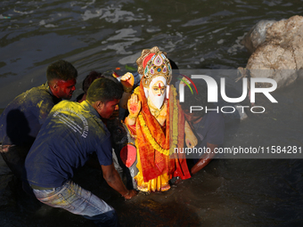 Nepali Hindu devotees immerse the eco-friendly idol of Lord Bishwokarma in the Bagmati River in Kathmandu, Nepal, on September 18, 2024. Bis...