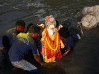 Nepali Hindu devotees immerse the eco-friendly idol of Lord Bishwokarma in the Bagmati River in Kathmandu, Nepal, on September 18, 2024. Bis...