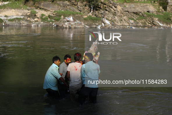 Nepali Hindu devotees immerse the eco-friendly idol of Lord Bishwokarma in the Bagmati River in Kathmandu, Nepal, on September 18, 2024. Bis...