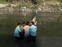 Nepali Hindu devotees immerse the eco-friendly idol of Lord Bishwokarma in the Bagmati River in Kathmandu, Nepal, on September 18, 2024. Bis...