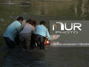 Nepali Hindu devotees immerse the eco-friendly idol of Lord Bishwokarma in the Bagmati River in Kathmandu, Nepal, on September 18, 2024. Bis...