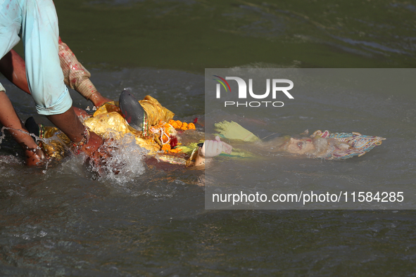 Nepali Hindu devotees immerse the eco-friendly idol of Lord Bishwokarma in the Bagmati River in Kathmandu, Nepal, on September 18, 2024. Bis...