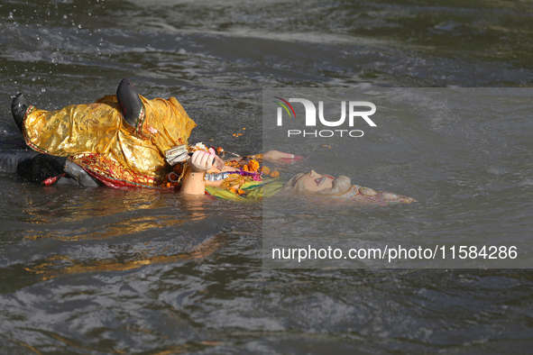 Nepali Hindu devotees immerse the eco-friendly idol of Lord Bishwokarma in the Bagmati River in Kathmandu, Nepal, on September 18, 2024. Bis...