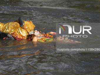 Nepali Hindu devotees immerse the eco-friendly idol of Lord Bishwokarma in the Bagmati River in Kathmandu, Nepal, on September 18, 2024. Bis...