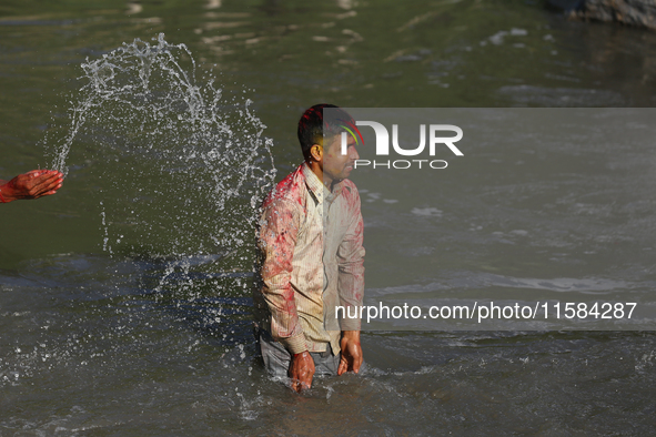 Nepali Hindu devotees immerse the eco-friendly idol of Lord Bishwokarma in the Bagmati River in Kathmandu, Nepal, on September 18, 2024. Bis...