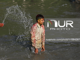 Nepali Hindu devotees immerse the eco-friendly idol of Lord Bishwokarma in the Bagmati River in Kathmandu, Nepal, on September 18, 2024. Bis...