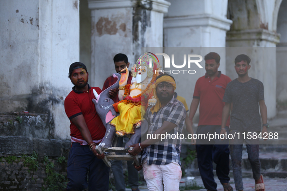 Nepali Hindu devotees carry an eco-friendly idol of Lord Bishwokarma to immerse it in the Bagmati River in Kathmandu, Nepal, on September 18...