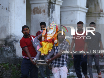 Nepali Hindu devotees carry an eco-friendly idol of Lord Bishwokarma to immerse it in the Bagmati River in Kathmandu, Nepal, on September 18...