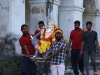 Nepali Hindu devotees carry an eco-friendly idol of Lord Bishwokarma to immerse it in the Bagmati River in Kathmandu, Nepal, on September 18...