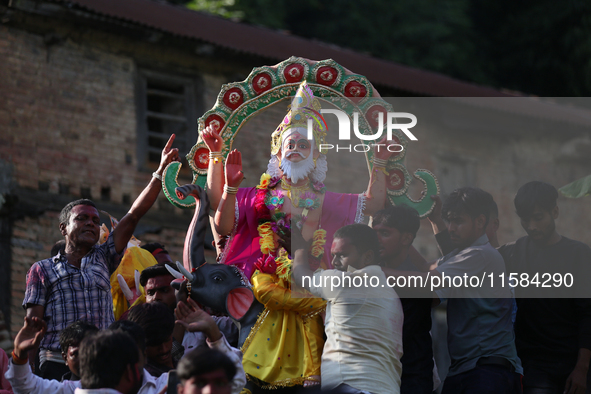 Nepali Hindu devotees carry an eco-friendly idol of Lord Bishwokarma to immerse it in the Bagmati River in Kathmandu, Nepal, on September 18...