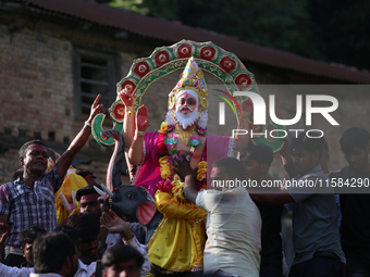 Nepali Hindu devotees carry an eco-friendly idol of Lord Bishwokarma to immerse it in the Bagmati River in Kathmandu, Nepal, on September 18...