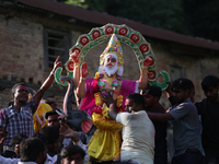 Nepali Hindu devotees carry an eco-friendly idol of Lord Bishwokarma to immerse it in the Bagmati River in Kathmandu, Nepal, on September 18...