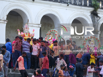 Nepali Hindu devotees carry an eco-friendly idol of Lord Bishwokarma to immerse it in the Bagmati River in Kathmandu, Nepal, on September 18...