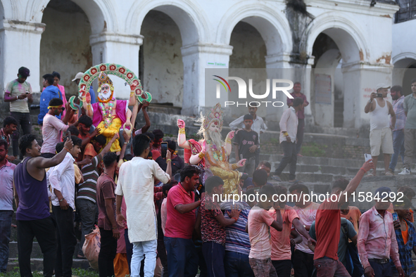 Nepali Hindu devotees carry an eco-friendly idol of Lord Bishwokarma to immerse it in the Bagmati River in Kathmandu, Nepal, on September 18...