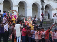 Nepali Hindu devotees carry an eco-friendly idol of Lord Bishwokarma to immerse it in the Bagmati River in Kathmandu, Nepal, on September 18...