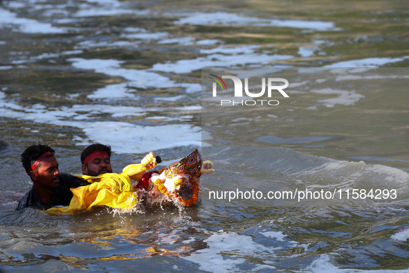 Nepali Hindu devotees immerse the eco-friendly idol of Lord Bishwokarma in the Bagmati River in Kathmandu, Nepal, on September 18, 2024. Bis...