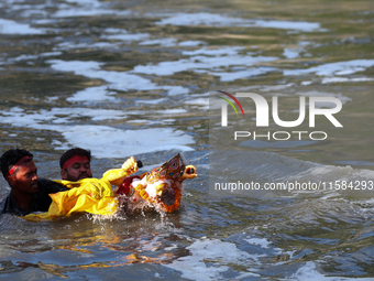 Nepali Hindu devotees immerse the eco-friendly idol of Lord Bishwokarma in the Bagmati River in Kathmandu, Nepal, on September 18, 2024. Bis...