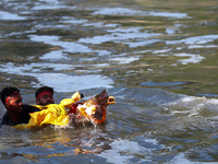 Nepali Hindu devotees immerse the eco-friendly idol of Lord Bishwokarma in the Bagmati River in Kathmandu, Nepal, on September 18, 2024. Bis...