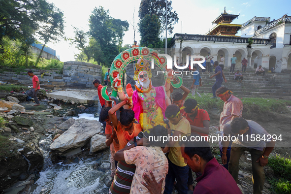 Nepali Hindu devotees carry an eco-friendly idol of Lord Bishwokarma to immerse it in the Bagmati River in Kathmandu, Nepal, on September 18...