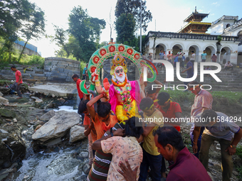 Nepali Hindu devotees carry an eco-friendly idol of Lord Bishwokarma to immerse it in the Bagmati River in Kathmandu, Nepal, on September 18...