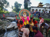 Nepali Hindu devotees carry an eco-friendly idol of Lord Bishwokarma to immerse it in the Bagmati River in Kathmandu, Nepal, on September 18...