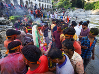 Nepali Hindu devotees perform rituals before they immerse an eco-friendly idol of the Hindu god Bishwokarma in the Bagmati River in Kathmand...