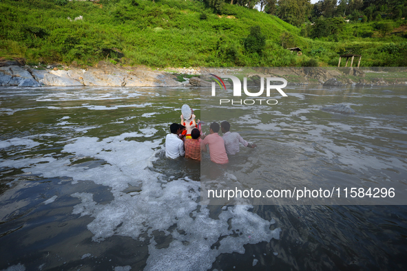 Nepali Hindu devotees immerse the eco-friendly idol of Lord Bishwokarma in the Bagmati River in Kathmandu, Nepal, on September 18, 2024. Bis...