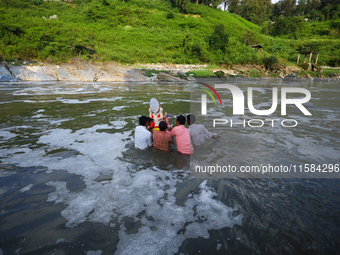 Nepali Hindu devotees immerse the eco-friendly idol of Lord Bishwokarma in the Bagmati River in Kathmandu, Nepal, on September 18, 2024. Bis...