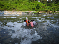 Nepali Hindu devotees immerse the eco-friendly idol of Lord Bishwokarma in the Bagmati River in Kathmandu, Nepal, on September 18, 2024. Bis...