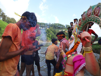 Nepali Hindu devotees perform rituals before they immerse an eco-friendly idol of the Hindu god Bishwokarma in the Bagmati River in Kathmand...