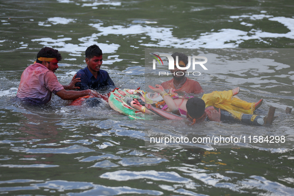 Nepali Hindu devotees immerse the eco-friendly idol of Lord Bishwokarma in the Bagmati River in Kathmandu, Nepal, on September 18, 2024. Bis...