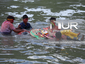 Nepali Hindu devotees immerse the eco-friendly idol of Lord Bishwokarma in the Bagmati River in Kathmandu, Nepal, on September 18, 2024. Bis...