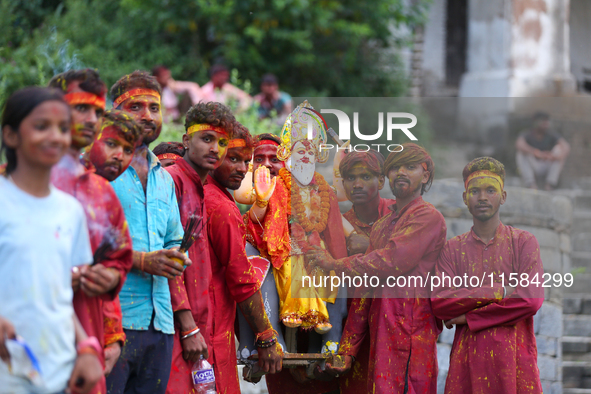 Nepali Hindu devotees carry an eco-friendly idol of Lord Bishwokarma to immerse it in the Bagmati River in Kathmandu, Nepal, on September 18...