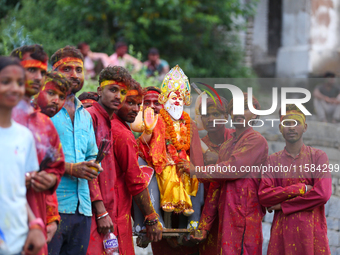 Nepali Hindu devotees carry an eco-friendly idol of Lord Bishwokarma to immerse it in the Bagmati River in Kathmandu, Nepal, on September 18...