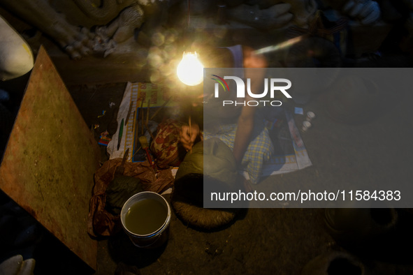 An artist makes the head of an idol ahead of the Durga Puja festival at a potters' hub in Kolkata, India, on September 18, 2024. 