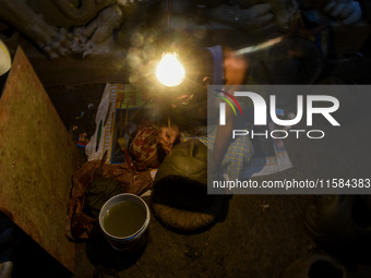 An artist makes the head of an idol ahead of the Durga Puja festival at a potters' hub in Kolkata, India, on September 18, 2024. (