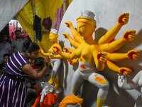 A female artist gives final touches to an idol of goddess Durga ahead of the Durga Puja festival at her workshop in Kolkata, India, on Septe...