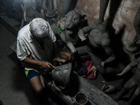 An artist makes the head of an idol ahead of the Durga Puja festival at a potters' hub in Kolkata, India, on September 18, 2024. (