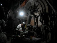 An artist makes the head of an idol ahead of the Durga Puja festival at a potters' hub in Kolkata, India, on September 18, 2024. (