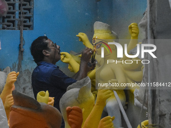 An artist gives final touches to an idol of goddess Durga ahead of the Durga Puja festival at a workshop in Kolkata, India, on September 18,...