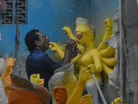 An artist gives final touches to an idol of goddess Durga ahead of the Durga Puja festival at a workshop in Kolkata, India, on September 18,...